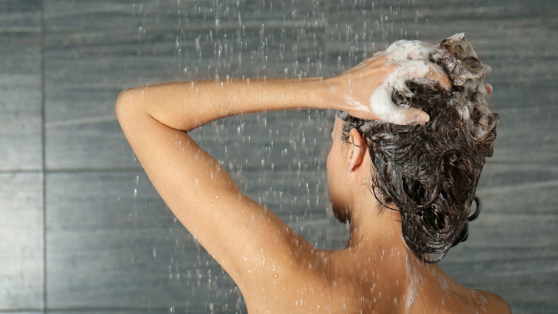Woman in shower washing her hair
