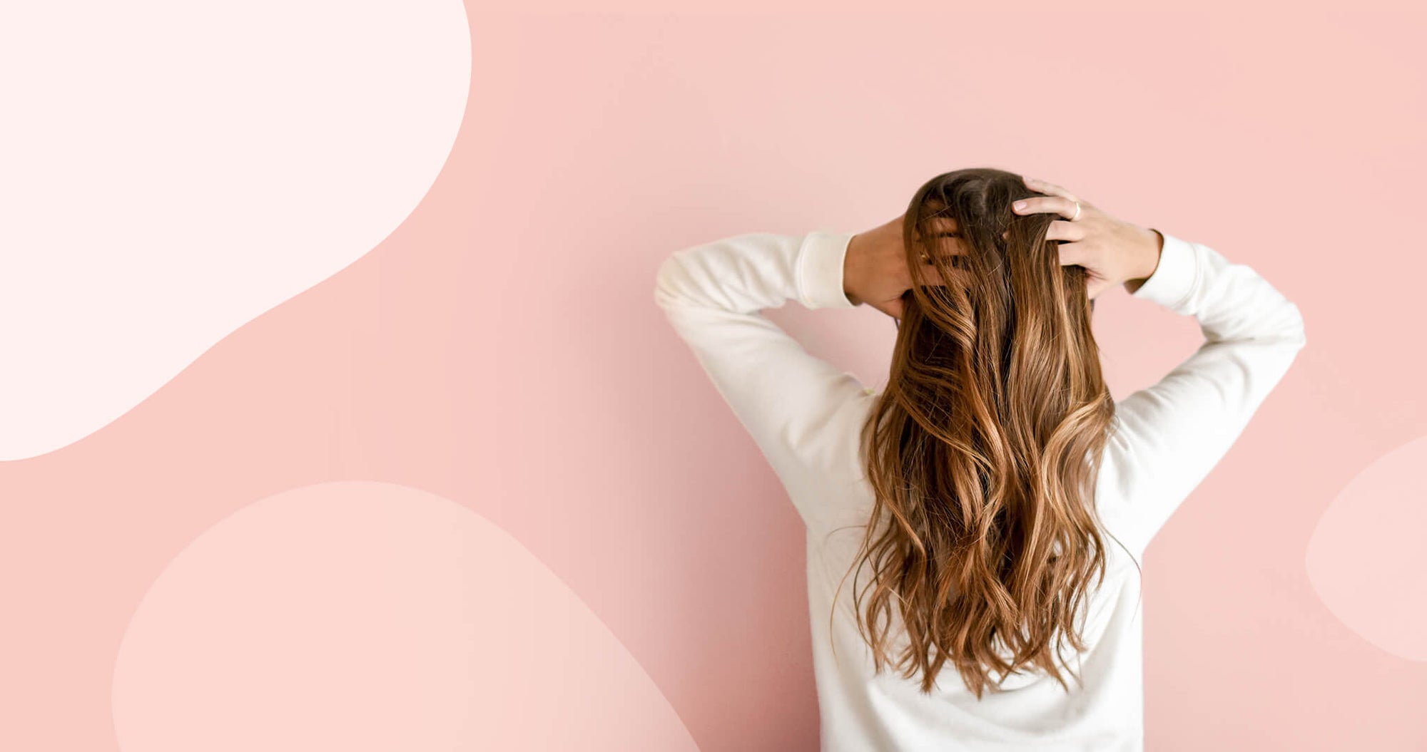 Woman with long hair on pink background